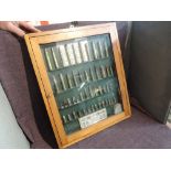 A wooden and glass display case containing inert Bullets, various all deactivated 48 bullets