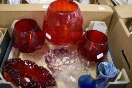 A collection of coloured glass including three vintage red goblet vases and a similar art glass