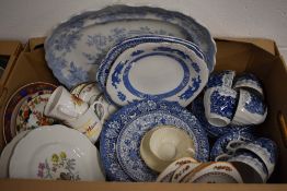 A collection of mainly blue and white tableware items including a set of matching cups, saucers