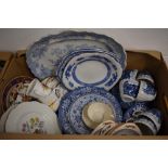 A collection of mainly blue and white tableware items including a set of matching cups, saucers