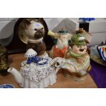 Four novelty tea pots including Tony Wood cat design, a Coronation deaf man and the village