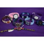 Eight ladies watches in a variety of styles and colours.