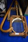 Two vintage racquets one tennis and one squash both with wooden brace supports, a cane handled