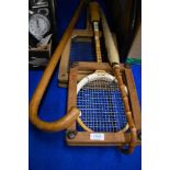 Two vintage racquets one tennis and one squash both with wooden brace supports, a cane handled