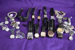 A selection of wrist watches having black straps or in silver tones.