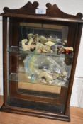 A vintage wooden and glazed display case containing modern miniature Bonnie Bears, similar resin