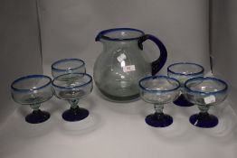 A vintage Egyptian style two tone glass jug and goblet set in blue and aqua green glass.