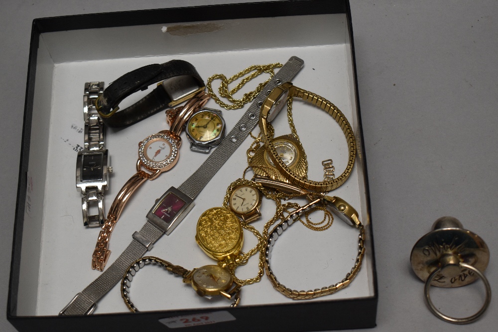 Seven ladies fashion wristwatches with a yellow metal locket.