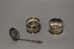 Two early 20th century HM silver napkin rings with a small HM silver strainer.