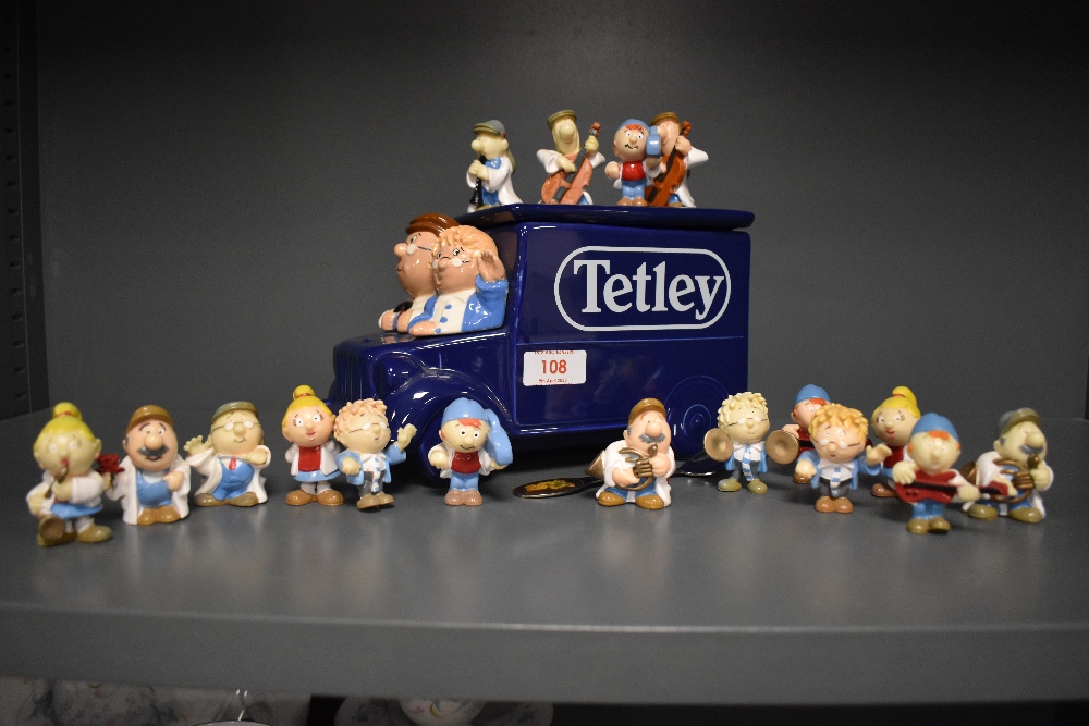 A collection of vintage Tetley tea advertising figures and a van form biscuit barrel.