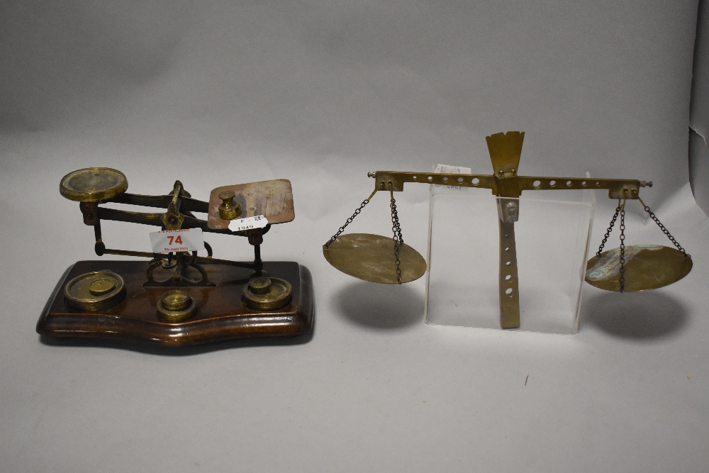 A set of vintage postal scales with a similar partial set and some brass weights.