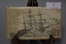 A late Victorian sailors scrimshaw pan-bone plaque carved depicting a Whaling ship in stormy waters,
