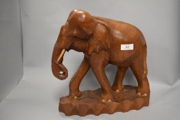A large wooden Indian elephant in Teak or similar wood. 34cm tall.