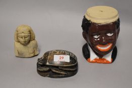 Two Egyptian items including stone carved scarab beetle and a bust with a vintage character mug.