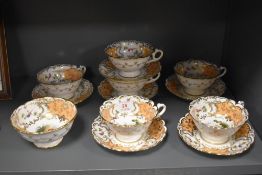A set of six Coalport hand decorated tea cup and saucers with a sugar bowl. Decorated with birds