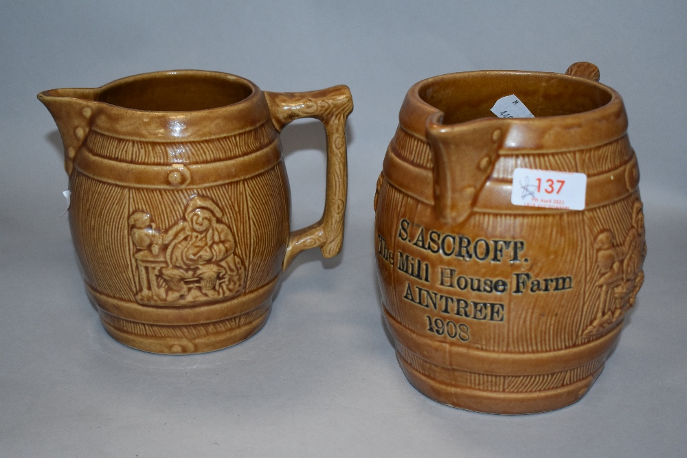 Two early 20th century barrel form milk jugs with impressed harvest scenes, one marked S Ashcroft,