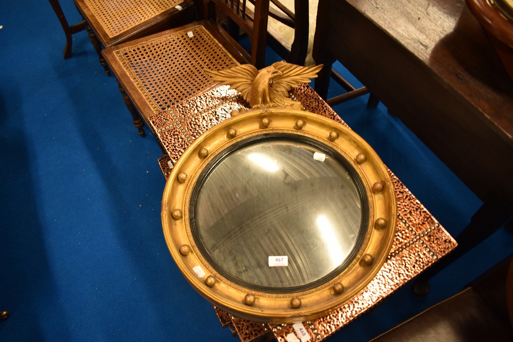 A gilt frame convex wall mirror having ball and eagle decoration (af)