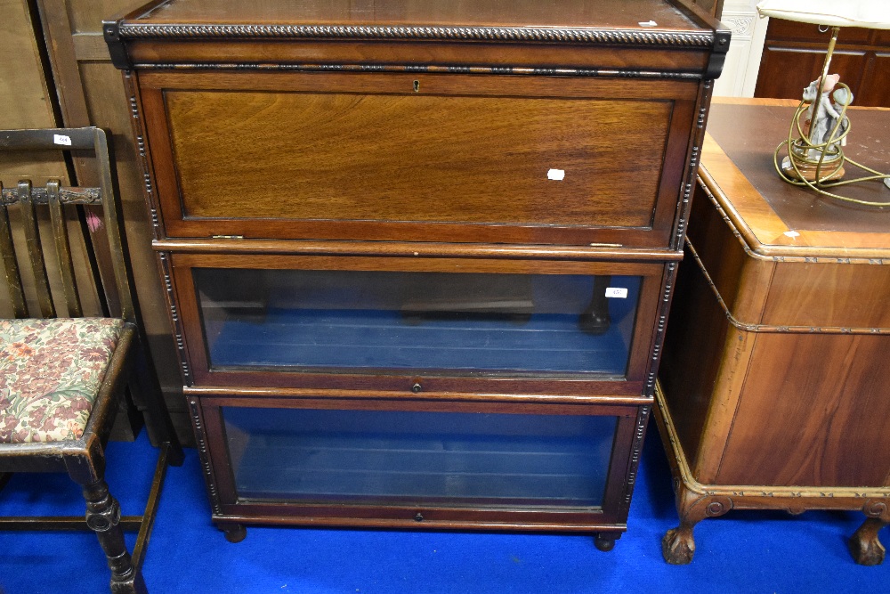 A late 19th/early 20th Century mahogany stacking bookcase having three tiers comprising bureau and