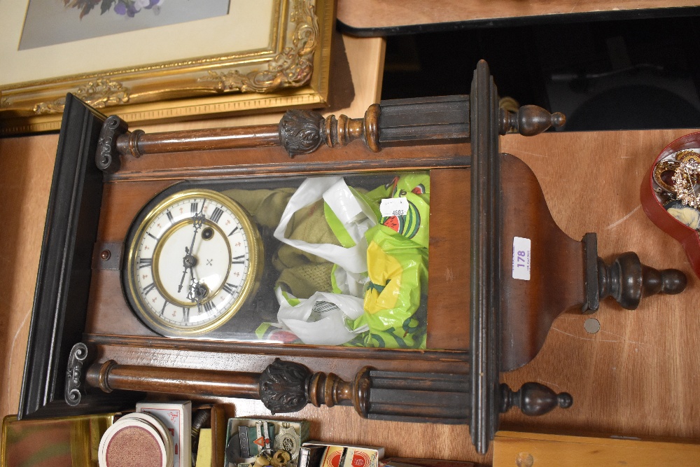 A late Victorian Vienna styled wall clock having an enamel dial with a veneer and carved case.