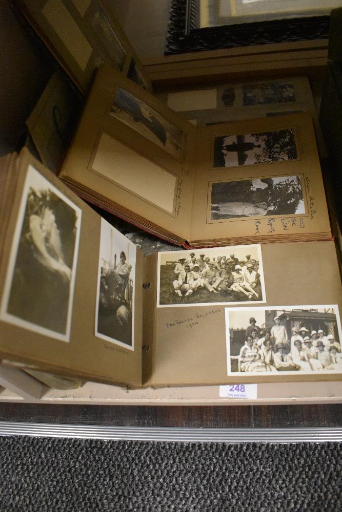 A collection of early 20th century black and white photograph albums.