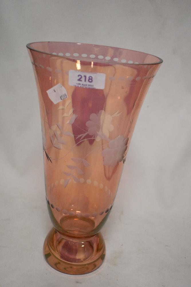 A modern pink lustre glass vase having an etched floral design.