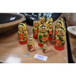 A set of nine vintage Russian 'USSR' Matrioshka dolls hand painted in traditional designs, each doll