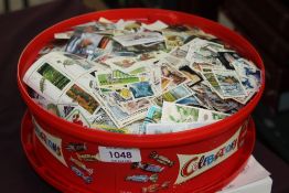 WORLD STAMP COLLECTION, MINT & USED IN OLD SWEET TUB SEVERAL THOUSAND STAMPS Old tub full of