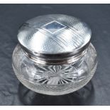 A George V silver topped glass powder bowl, of slightly domed circular top with engine-tuned