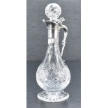 A Queen Elizabeth II silver mounted cut-crystal claret jug, having a star-cut spherical stopper over