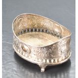 A 19th century white metal coaster, of oval form form with moulded rim and profuse embossed