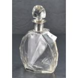 An Art Deco period silver-mounted cut-glass decanter, having a domed facet-cut stopper over the