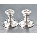 A pair of early Elizabeth II silver squat or dwarf candlesticks, with reed moulded decoration, marks