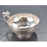 A continental white metal cup, of circular ogee form with moulded rim and band of repeating lappet