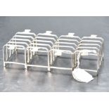 A group of four Art Deco design silver four division toast racks, each of rectangular form with