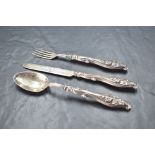 A Victorian silver christening set, comprising silver bladed knife, fork and spoon, the handles with