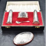 A cased Queen Elizabeth II silver three-piece condiment set, comprising salt cellar, pepperette