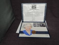 A Queen Elizabeth II Guernsey Gold 1oz 5 Pound Coin on large hand painted Queen 75th Birthday