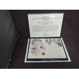 A Queen Elizabeth II Guernsey 2001 1/4 ounce Gold 25 Pound Coin on large hand painted watercolour