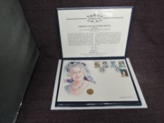A Queen Elizabeth II Guernsey 2001 1/4 ounce Gold 25 Pound Coin on large hand painted watercolour
