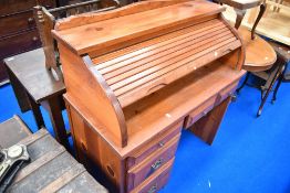 A vintage pine roll top desk