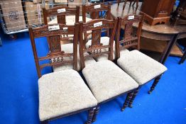 A set of five Victorian mahogany dining chairs having carved backs, with later upholstered