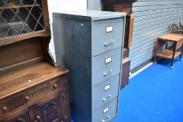 An industrial style four drawer metal filing cabinet