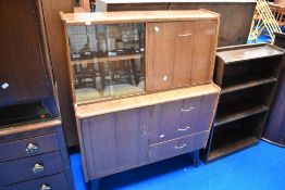 A mid Century sapele bureau with display section over cupboard and three drawer base, width