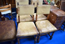 A set of four oak and leather dining chairs