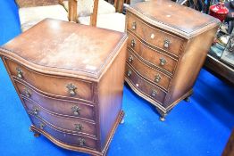 A pair of reproduction Regency serpentine front bedside chests of drawers
