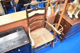 A 19th Century ladder back chair in the Macclesfield style having rush seat (af)