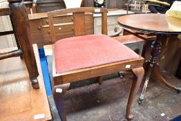 An early 20th Century piano or dressing table stool with dralon seat and cabriole legs