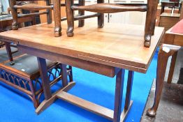 An early to mid 20th Century drawer leaf dining table having Arts and Crafts style frame