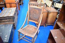 A 19th Century stained frame rocking chair having decorative ply seat and back