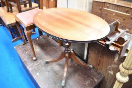 A reproduction Regency style oval top coffee table